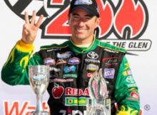 Marcos Ambrose raises three fingers in recognition of his third consecutive NASCAR Nationwide Series victory at Watkins Glen International Saturday in Watkins Glen, N.Y. Credit: Rusty Jarrett/Getty Images for NASCAR